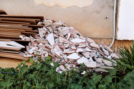 Construction waste. A pile of construction waste. Building rubble and stones. Abandoned garbage, junk, garbage piled up near the building. Street scene. Recycling industry. Ecology. Not Ecology.の写真素材