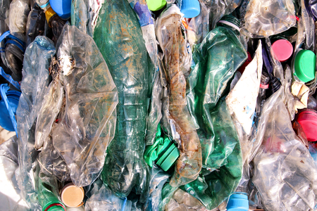 Plastic bottles on pile, ready to get recycled. Recycling of old plastic bottles. Pile of packed and...