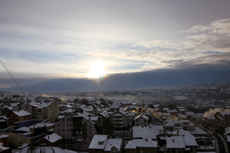 Beautiful view of winter morning fog, snow and sun filling on landscape of houses and buildings in Belgrade.の写真素材