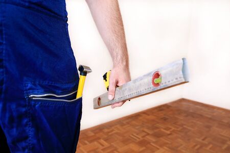 Construction worker at construction site with protective uniform, construction service tools and...