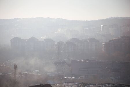 Winter morning atmosphere view on landscape of houses and buildings with fog covered street....
