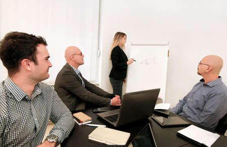 Businesswoman and leader team use white board drawing explains colleagues graph of development...