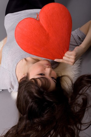 Beautiful woman holding red heartの写真素材