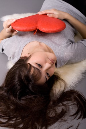 Beautiful woman holding red heartの写真素材