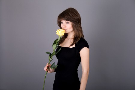 Beautiful girl with yellow roseの写真素材