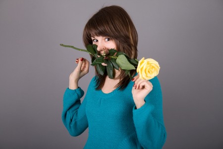 Beautiful girl with yellow roseの写真素材