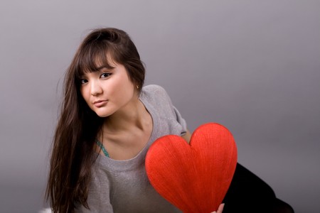 Beautiful woman holding red heartの写真素材