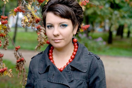 Pretty girl walking in autumn parkの写真素材