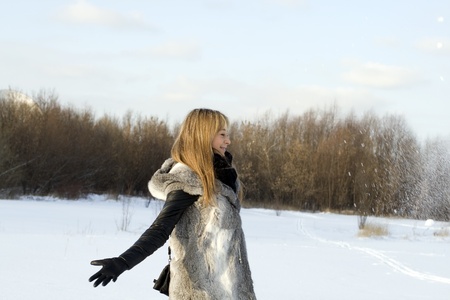 Girl walking in winter fieldの写真素材