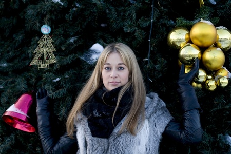 Girl standing near fir-treeの写真素材