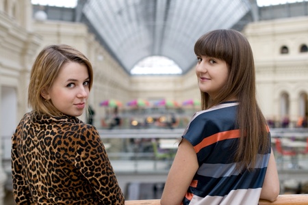 Two female friends walking in a shopの写真素材