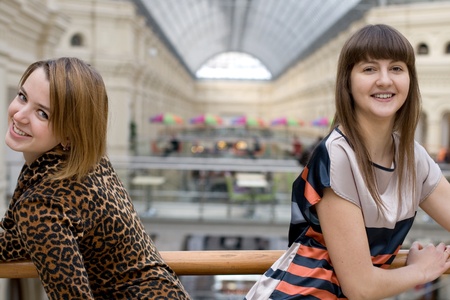 Two female friends walking in a shopの写真素材