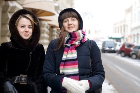 Two female friends walking outdoorの写真素材