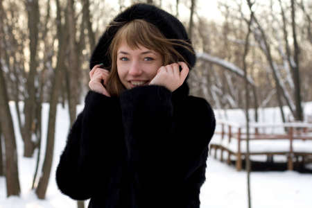 Portrait of a girl walking in park in winterの写真素材