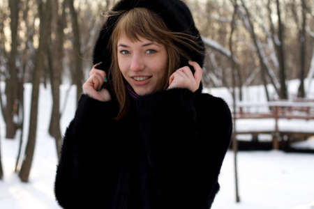 Portrait of a girl walking in park in winterの写真素材