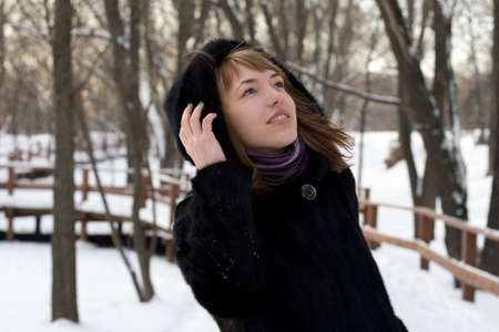 Portrait of a girl walking in park in winterの写真素材