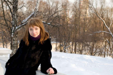Portrait of a girl walking in park in winterの写真素材