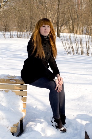Portrait of a girl walking in park in winterの写真素材