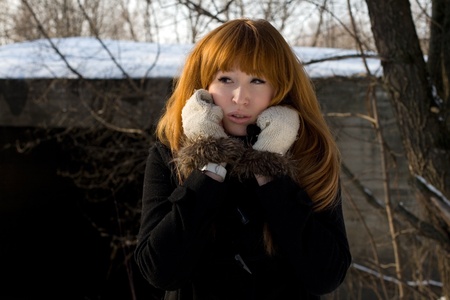 Portrait of a girl walking in park in winterの写真素材