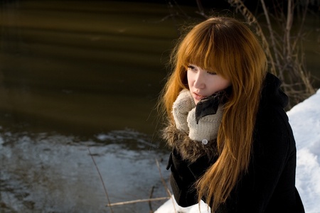 Portrait of a girl walking in park in winterの写真素材
