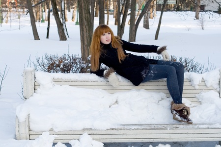 Portrait of a girl walking in park in winterの写真素材