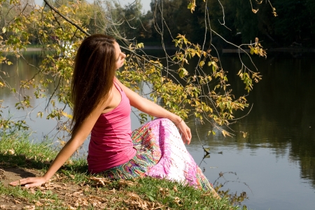 Beautiful girl in forest near pondの写真素材