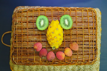 Assorted fruits on a background of a wicker basket. Spinning in a smileの写真素材