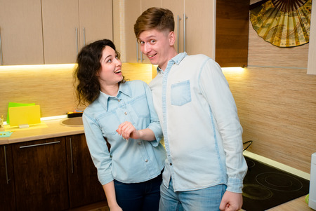 Young couple in love in the kitchenの写真素材