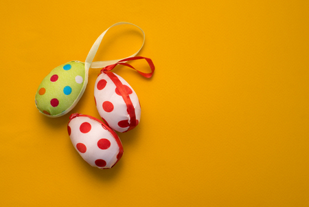 Easter eggs on a yellow background with a place for writingの写真素材