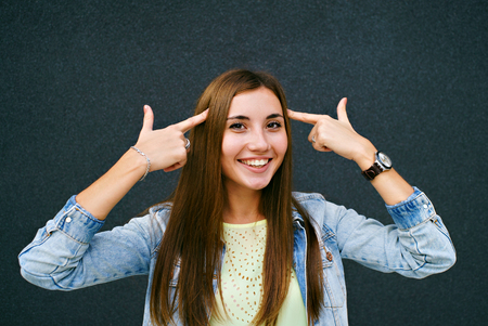 Girl fingers near the templesの写真素材