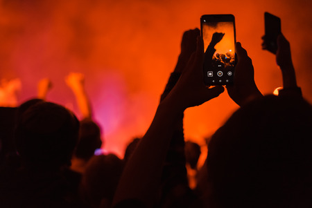 spectators at a concert phone close-up live broadcastの写真素材