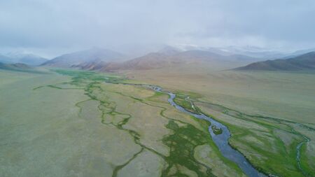 river flows along the mountains in Mongoliaの写真素材