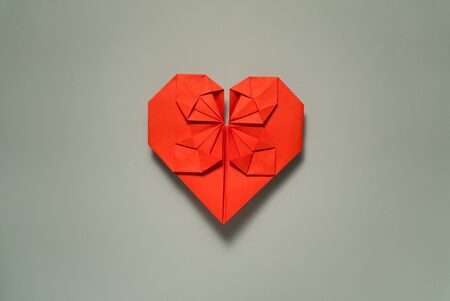 origami red paper heart centered on white background, valentines day greeting cardの写真素材