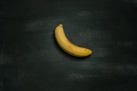 Art installation banana taped to a black wall の写真素材