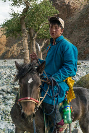 mongolia, gobi, 19 sep 2019-Mongolian youth on a horse in national dressのeditorial素材