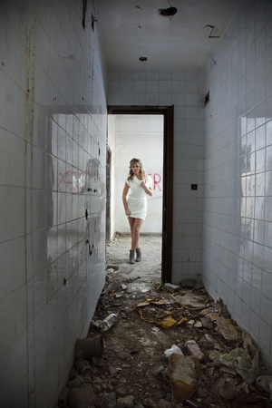 Sexy girl with expression of fear in abandoned buildingの写真素材