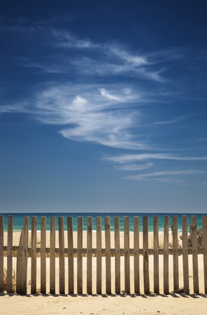 sky with clouds on the beach with a wooden fenceの写真素材