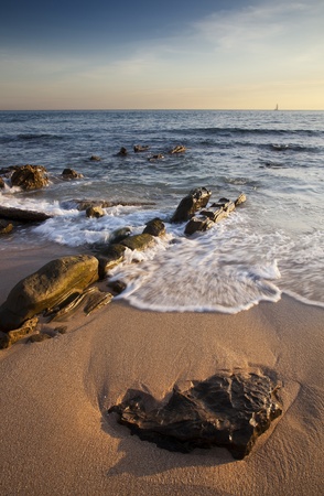 Rocky beach at sunsetの写真素材