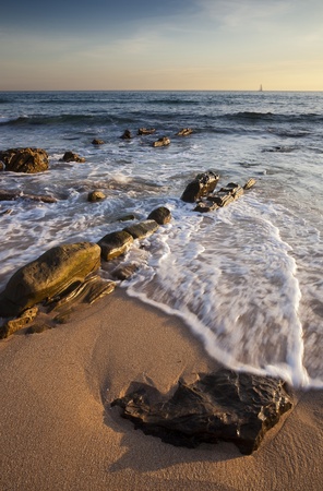 Rocky beach at sunsetの写真素材