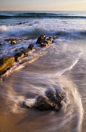 Rocky beach at sunsetの写真素材