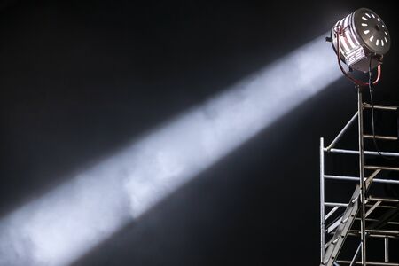 strong and focused diagonal light ray from a movie lighting spotlight