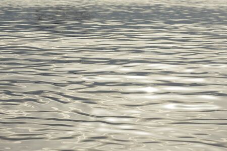 abstract calm ocean water ripples with slight reflective highlights texture backgroundの写真素材