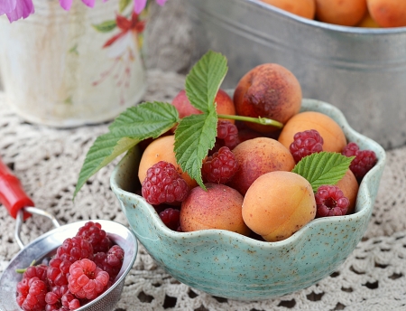 ripe ,organic  apricots fruit in to the blue  bowl