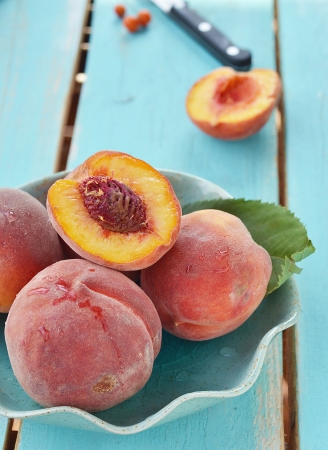 ripe ,organic  peaches in to the ceramic  bowlの写真素材
