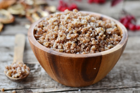 buckwheat groats in a wooden bowlの写真素材
