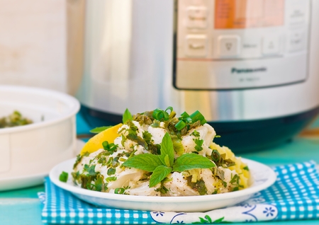 cod fillet with greens prepared in the crock-potの写真素材