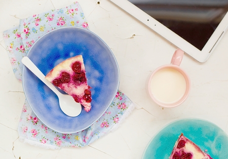 cottage cheese pudding with cherry, a milk cup for a breakfast on a white tableの写真素材