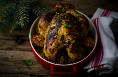 the baked chicken on a rustic background with a New Year's decor in vintage style. selective focus.の写真素材
