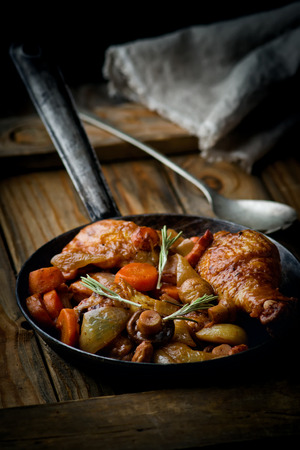 chicken with mushrooms and vegetables, stewed in wine. Style rustic . French cuisineの写真素材