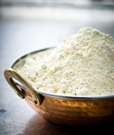 Flour from chick-pea in the Indian copper bowl on a metal background. selective focusの写真素材